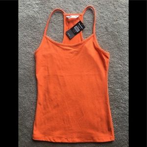 Brand new racerback tank never worn too small.